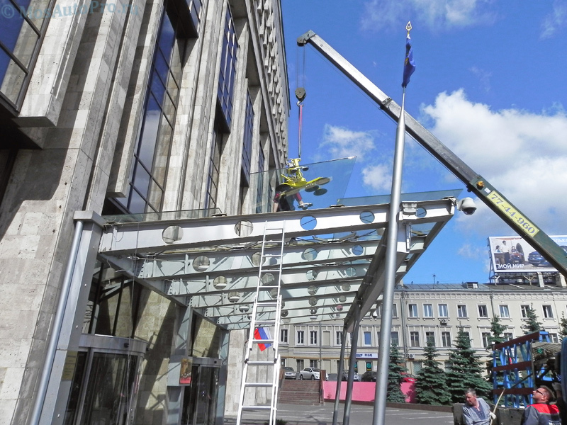 Монтаж большого тяжелого стекла манипулятором с вакуумной присоской в центре Москвы.